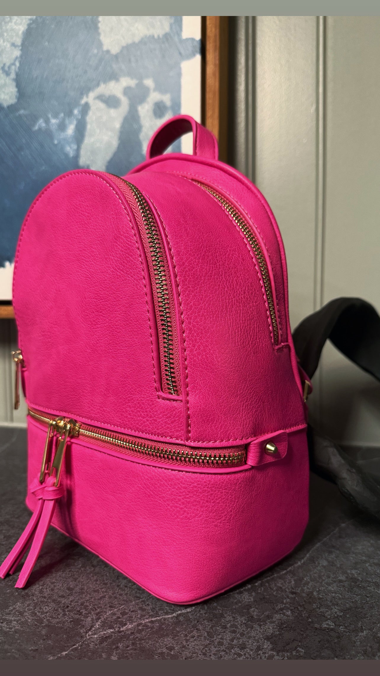 A small Fushia synthetic leather backpack 