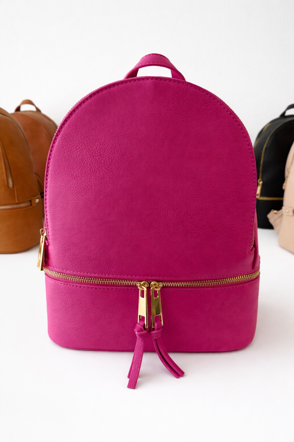 Pink backpack with gold zipper on a white background